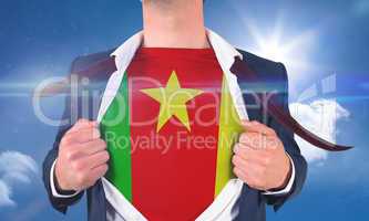 Businessman opening shirt to reveal cameroon flag