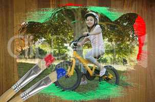 Composite image of little girl on a bike
