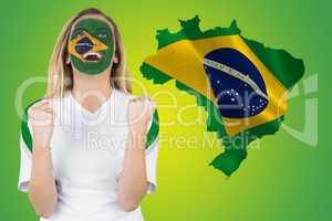 Excited brasil fan in face paint cheering