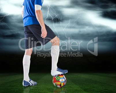 Football player standing with international ball