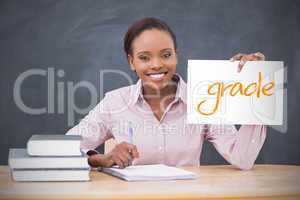 Happy teacher holding page showing grade