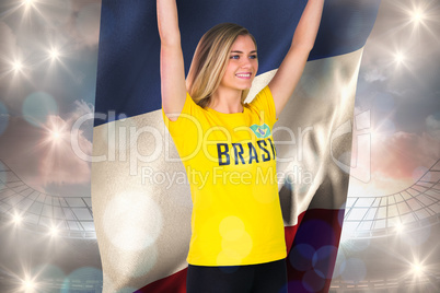 Excited football fan in brasil tshirt holding france flag