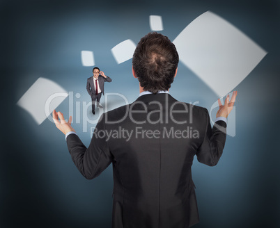 Composite image of gesturing businessman with tiny businessman