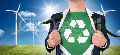 Composite image of businessman opening shirt in superhero style