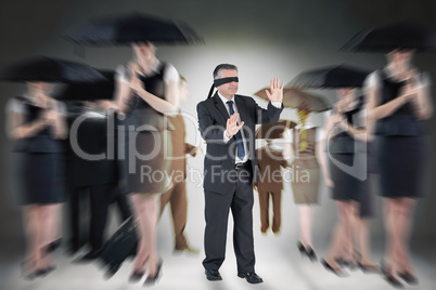 Composite image of mature businessman in a blindfold