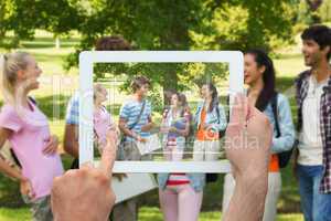 Composite image of hand holding tablet pc