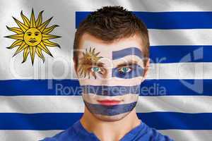 Serious young uruguay fan with facepaint