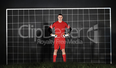 Composite image of goalkeeper in red looking at camera Composite image of goalkeeper in red looking at camera