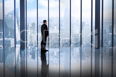 Composite image of businessman standing