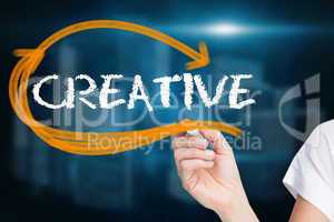 Businesswoman writing the word creative