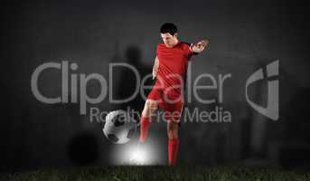 Composite image of football player in red kicking