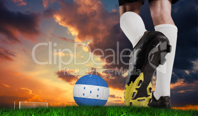 Composite image of football boot kicking honduras ball