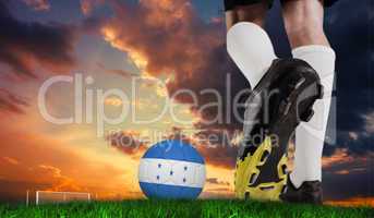 Composite image of football boot kicking honduras ball