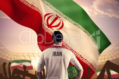 Composite image of iran football player holding ball