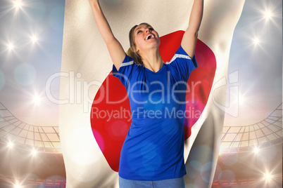 Composite image of cheering football fan in blue jersey holding