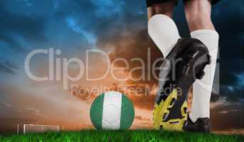 Composite image of football boot kicking nigeria ball