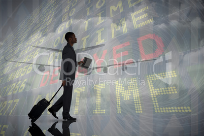 Composite image of young businessman pulling his suitcase