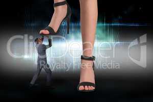 Composite image of female feet in black sandals stepping on busi