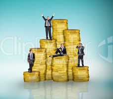 Composite image of business people on pile of coins