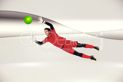 Composite image of fit goal keeper jumping up