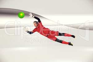 Composite image of fit goal keeper jumping up