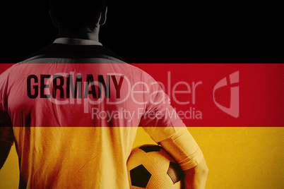 Composite image of germany football player holding ball