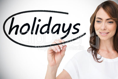 Businesswoman writing the word holidays