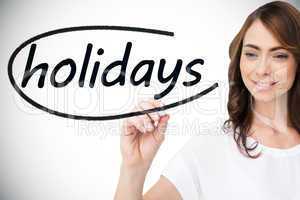 Businesswoman writing the word holidays