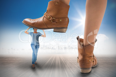 Composite image of cowboy boots stepping on girl