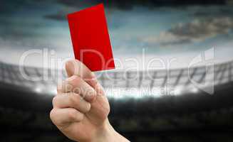 Composite image of hand holding up red card