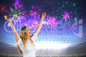 Composite image of pretty football fan in white cheering