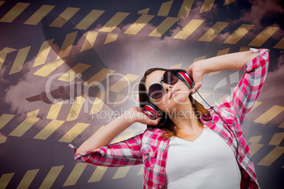 Composite image of casual brunette listening to music