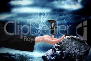 Composite image of young businesswoman holding umbrella in large