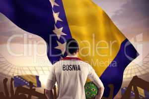 Composite image of bosnia football player holding ball