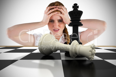 Composite image of stressed businesswoman with hands on head