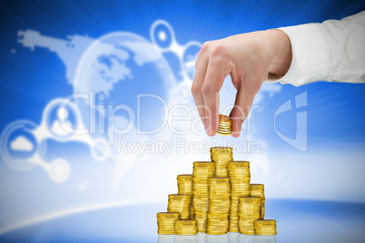 Composite image of businessman holding coins