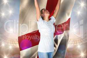 Composite image of pretty football fan in white cheering holding