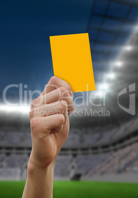 Composite image of hand holding up yellow card