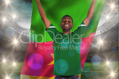 Composite image of cheering football fan in green jersey holding