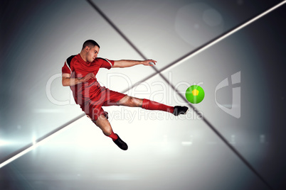 Composite image of fit football player playing and kicking