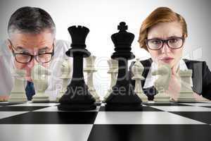 Composite image of business people and chessboard