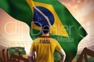 Composite image of brasil football player holding ball