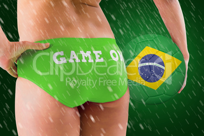 Composite image of fit girl holding brasil ball