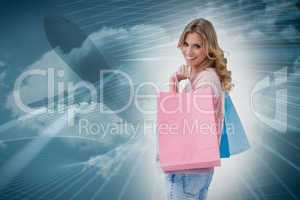 Composite image of a woman carrying shopping bags