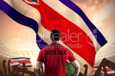 Composite image of costa rica football player holding ball