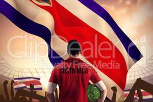 Composite image of costa rica football player holding ball