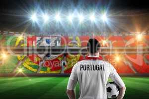 Composite image of portugal football player holding ball