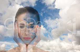 Composite image of beautiful brunette with hands on face