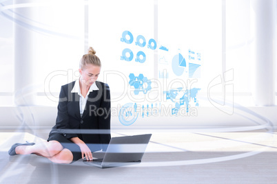 Composite image of businesswoman using laptop