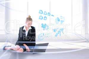 Composite image of businesswoman using laptop